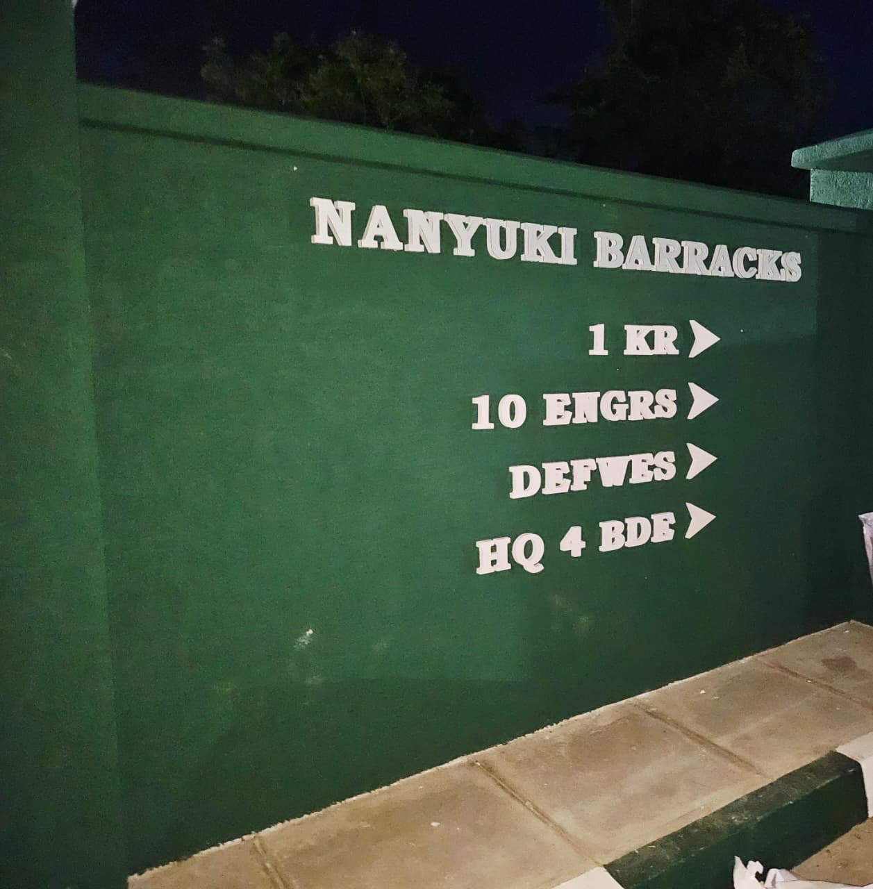 Raised-letter wall signage illuminated at night