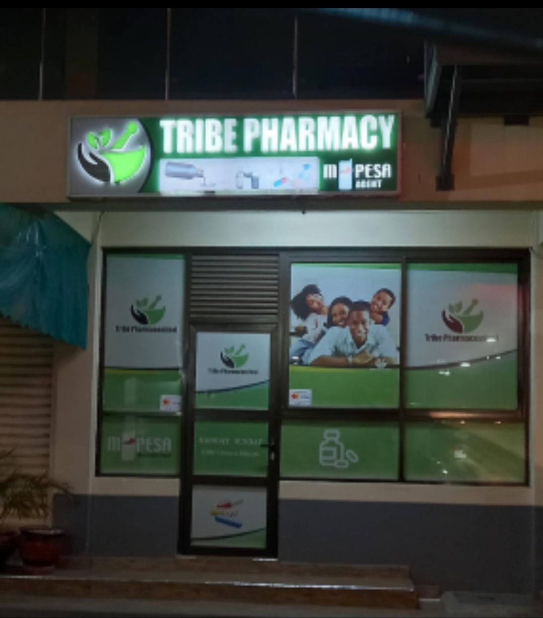 Tribe Pharmacy illuminated lightbox sign and window graphics